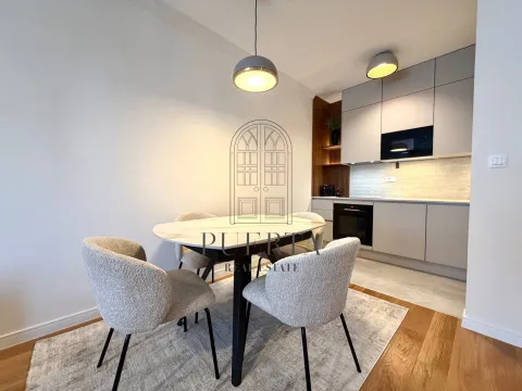 Modern kitchen with dining area and built-in appliances. - image 4