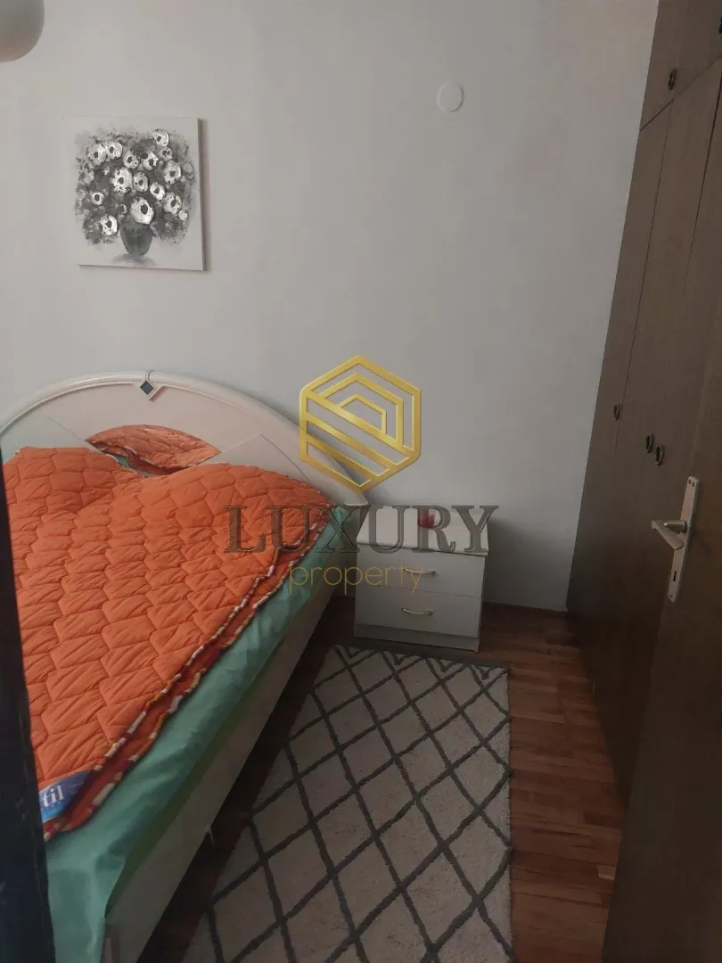 Bedroom with a double bed, wardrobe, and rug.