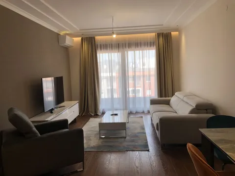 Bright living room with a seating area and a TV. - image 17