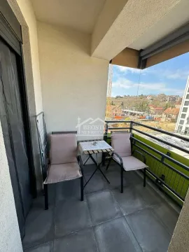 Covered terrace with a table and two chairs. - image 6