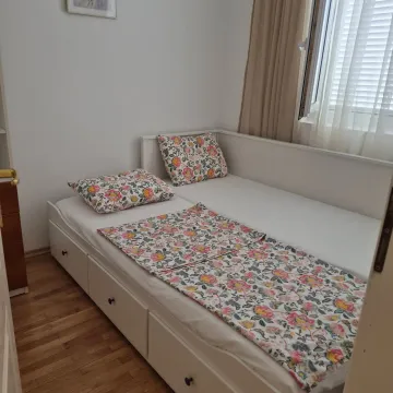 Small tidy bedroom with a white bed and a window. - image 7
