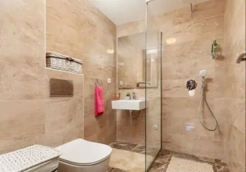 Modern tiled bathroom with a walk-in shower and a sink. - image 8