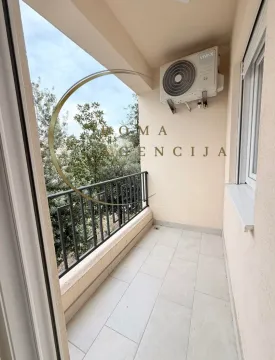 Covered balcony area with tiled floor and air conditioning unit. - image 9