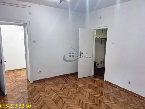 Empty room with parquet flooring and white walls. - image 3