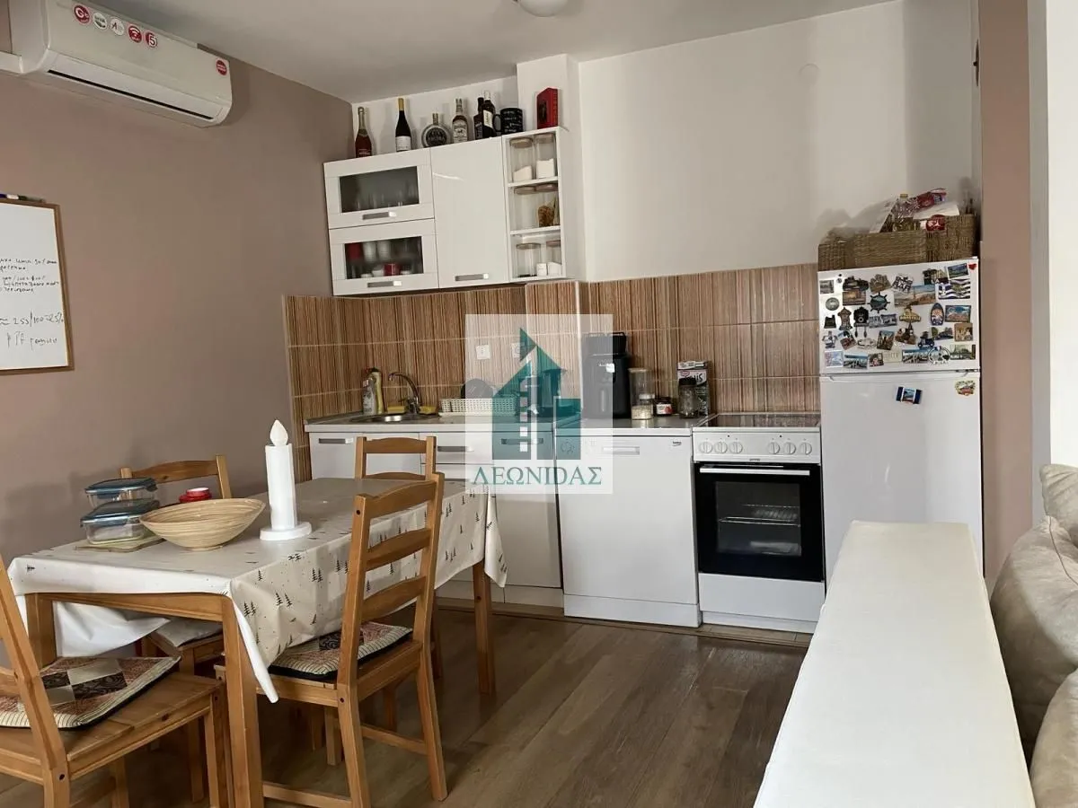 Kitchen with dining area and appliances.