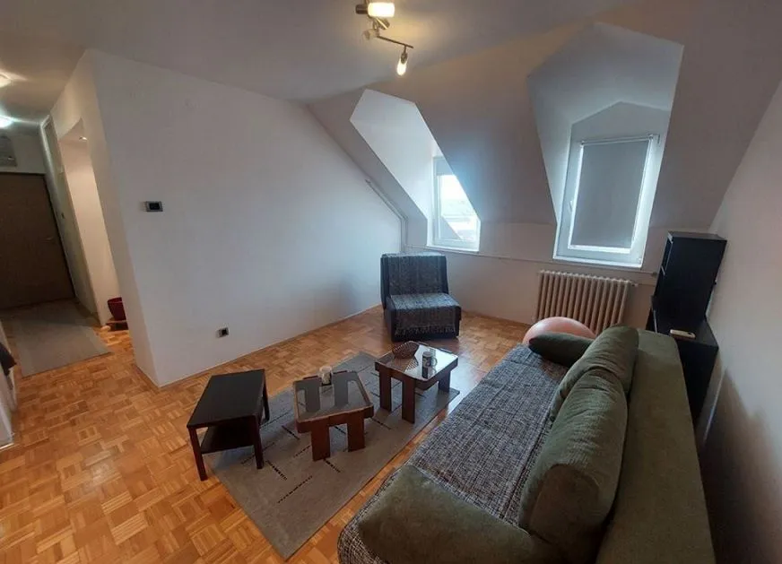 Living room with sofa and coffee tables in the attic.