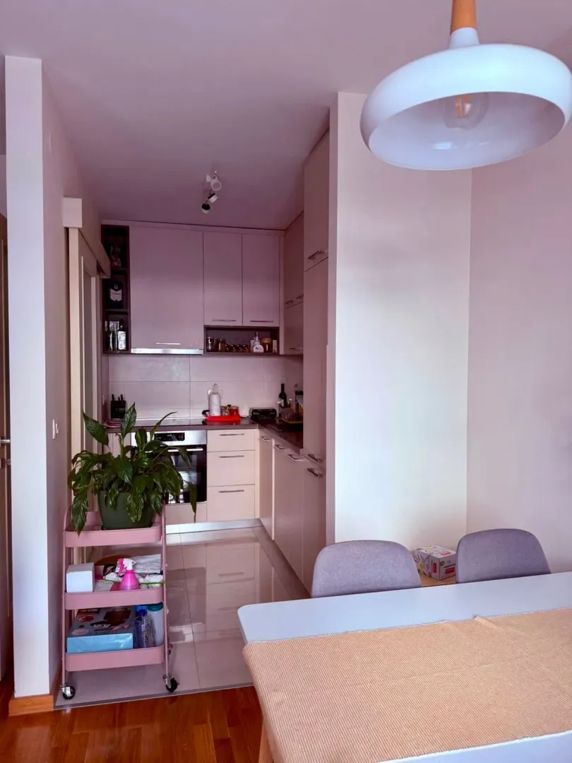 View of a modern kitchen with a dining table in the foreground.