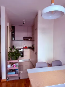 View of a modern kitchen with a dining table in the foreground. - image 4