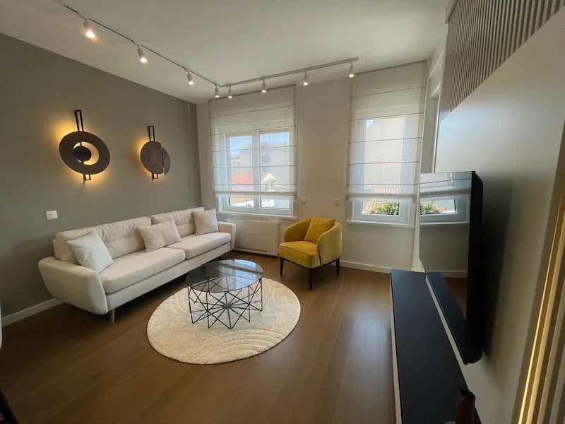Living room with a sofa, armchair and TV.