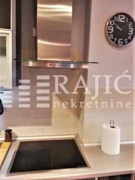 Part of the kitchen with a built-in hob and extractor hood. - image 3