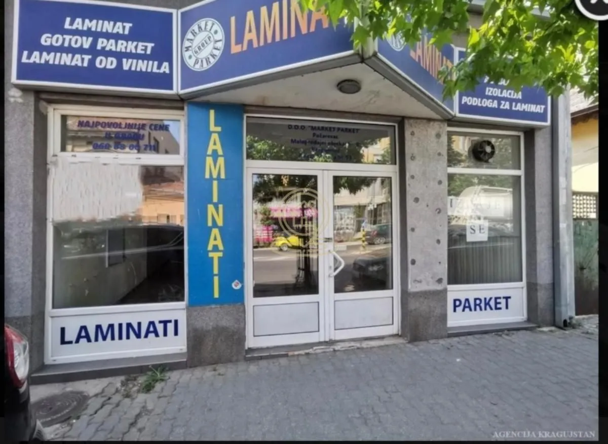 Exterior view of the commercial space with display windows and entrance signage.
