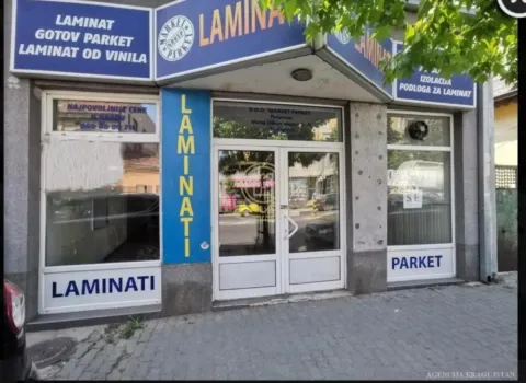 Exterior view of the commercial space with display windows and entrance signage. - image 4