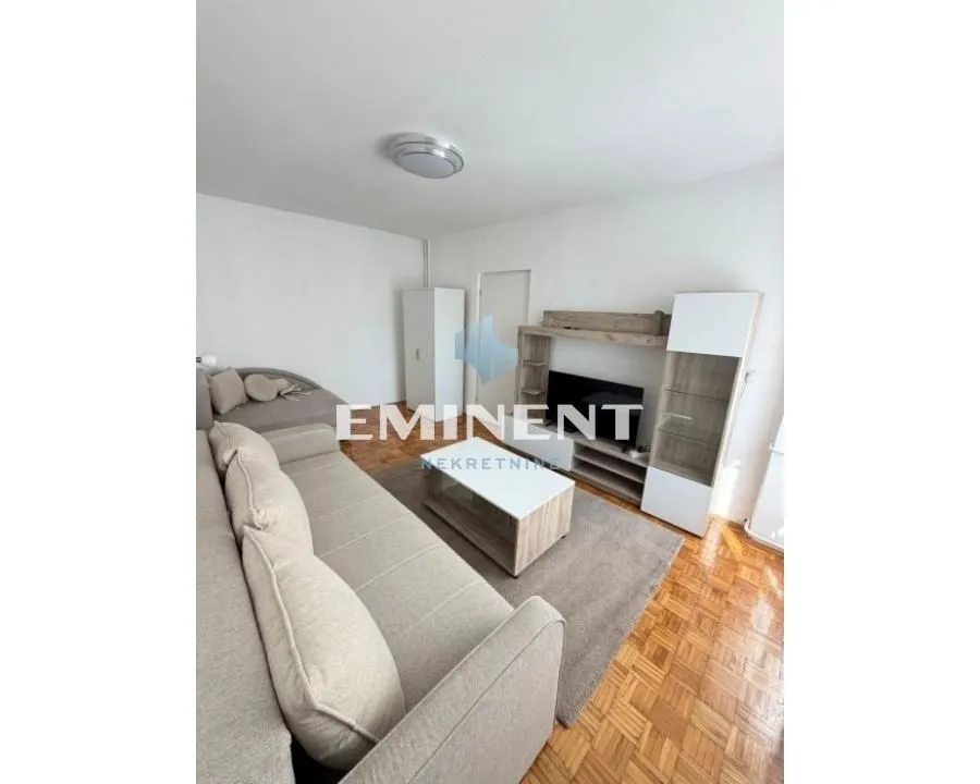 Living room with sofa, coffee table and TV unit.