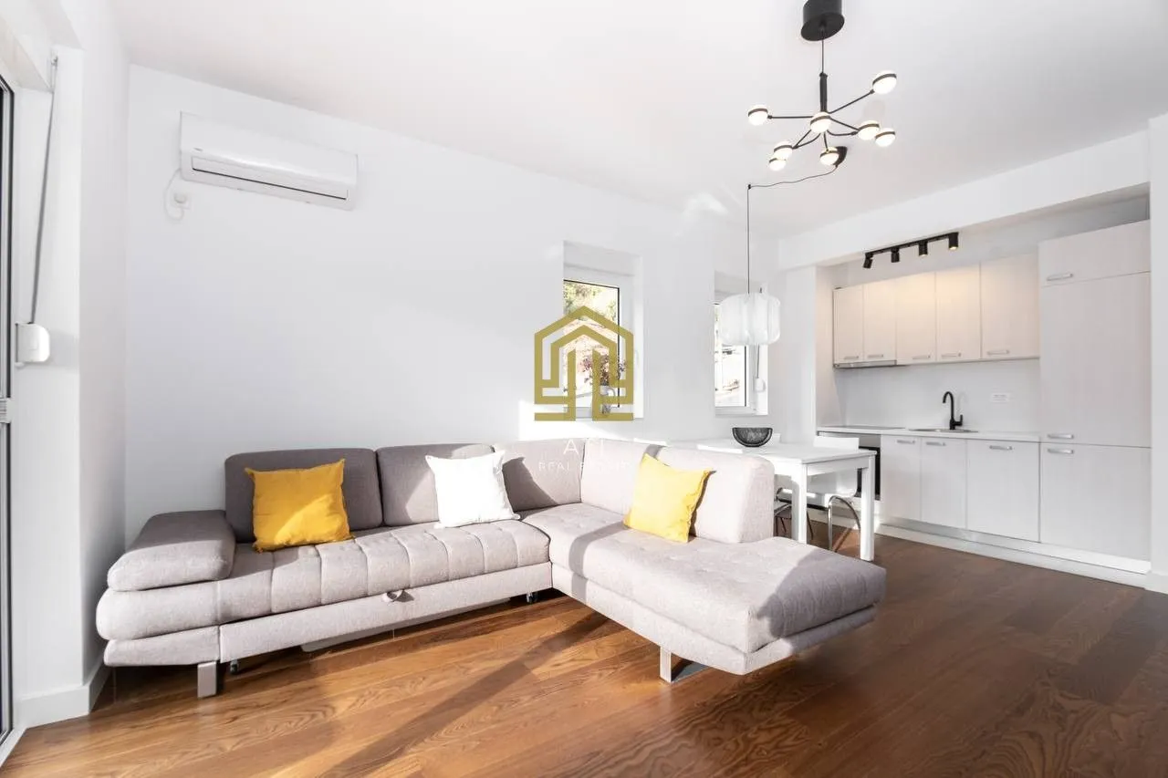 Living room with a corner sofa and a dining area in the back.