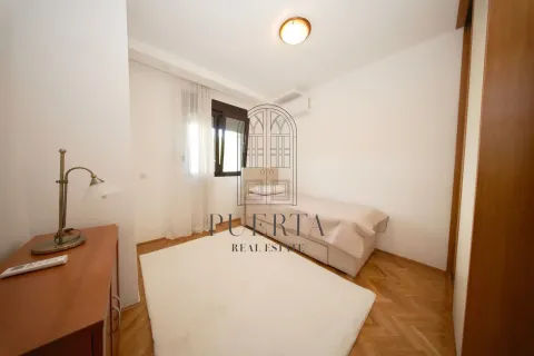 Small bedroom with a bed and wooden flooring. - image 12