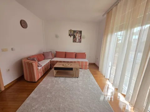 Living room with a sofa, coffee table, and large window. - image 17