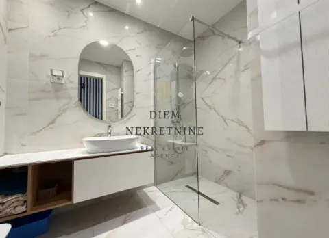 Modern bathroom with a sink and glass shower cabin. - image 8