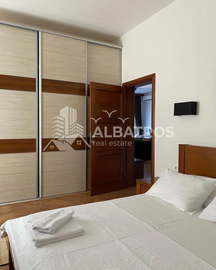 Furnished bedroom with a large double bed and a built-in wardrobe.