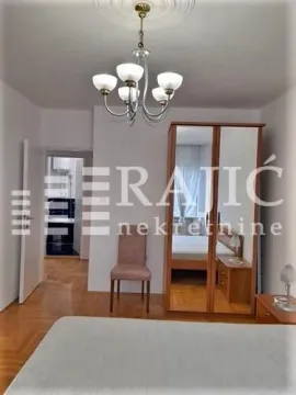 Furnished bedroom with a mirrored wardrobe and a chandelier. - image 3