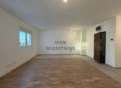 Empty living room with parquet flooring and white walls. - image 3