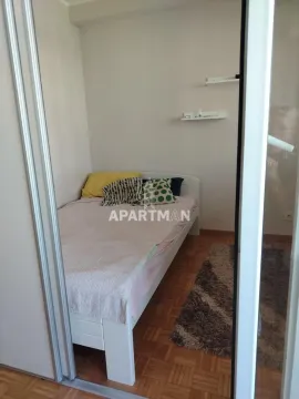 View of a smaller bedroom with a bed and parquet flooring. - image 6