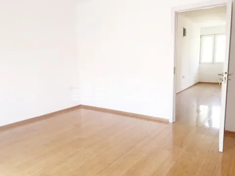 Empty room with wooden flooring and a doorway leading to another space. - image 12