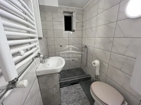 Small tiled bathroom with a walk-in shower area, washbasin and toilet. - image 6