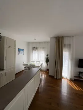 Living room with dining area and kitchen counter. - image 4