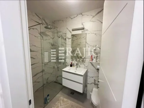 Modern bathroom with a walk-in shower and a vanity unit. - image 7