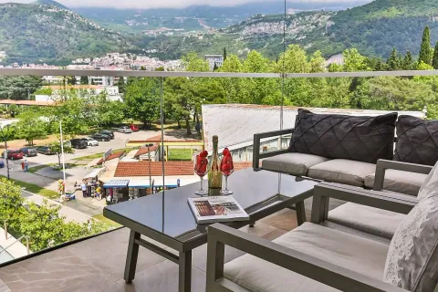 Furnished terrace with seating furniture and a view of the city and mountains. - image 10