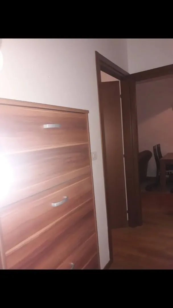 A wooden dresser next to an open doorway.