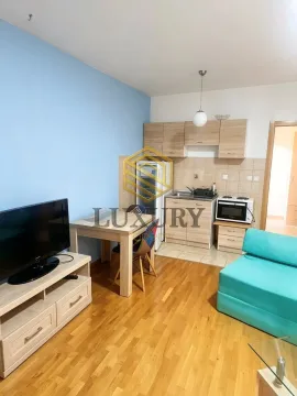 Living room with a kitchen and a dining table. - image 3