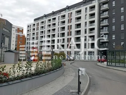 Exterior view of a residential building with a landscaped yard and playground.