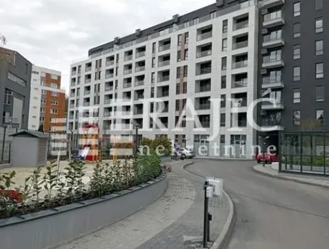 Exterior view of a residential building with a landscaped yard and playground. - image 2