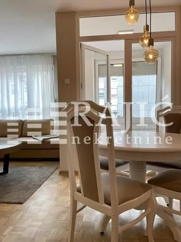 Living room with dining area and sofa set.