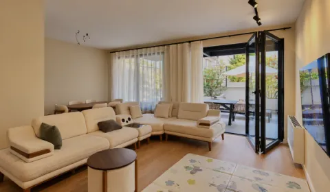 Spacious living room with a sofa and access to the terrace. - image 5