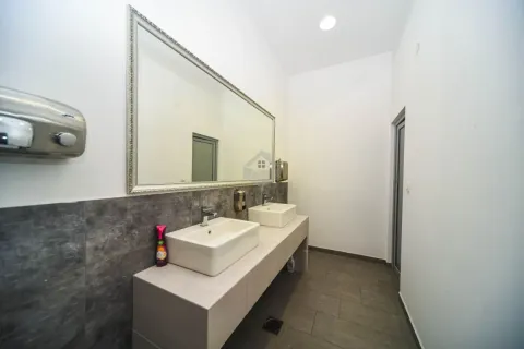 Modern bathroom equipped with two washbasins and a large mirror. - image 16