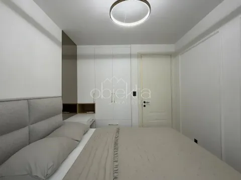 Furnished bedroom with a double bed, built-in wardrobe, and white doors. - image 10