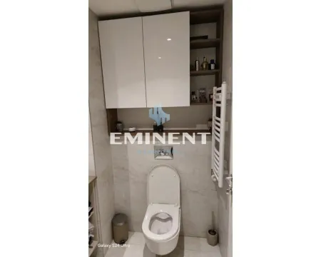 Modernly equipped bathroom with a wall-hung toilet and hanging cabinet. - image 12