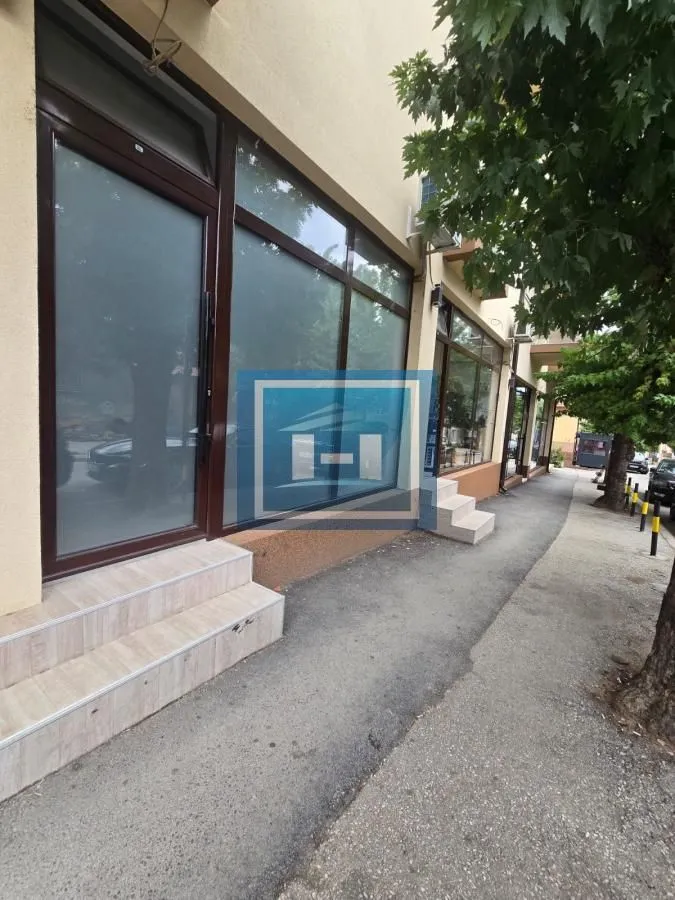 Exterior view of the building featuring an entrance door and large glass display windows.