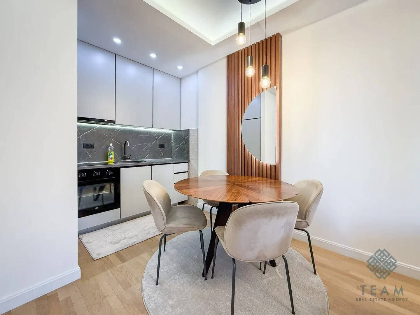 Modern kitchen with a dining table and chairs.