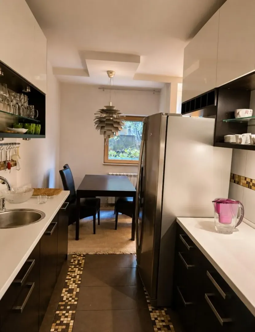 Small kitchen with a dining table and chairs near the window.