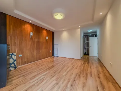 Prazna soba sa drvenim panelima na zidu i parketom na podu. - image 11