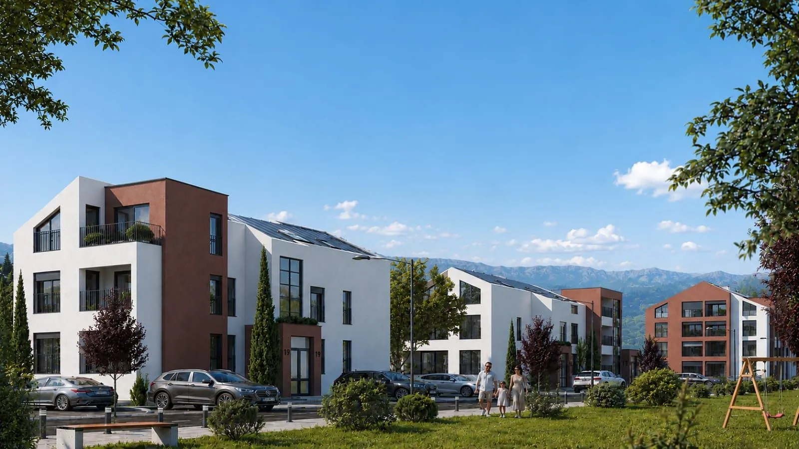 Spoljašnji izgled modernog stambenog kompleksa sa uređenim dvoriijem i parkiralištem.