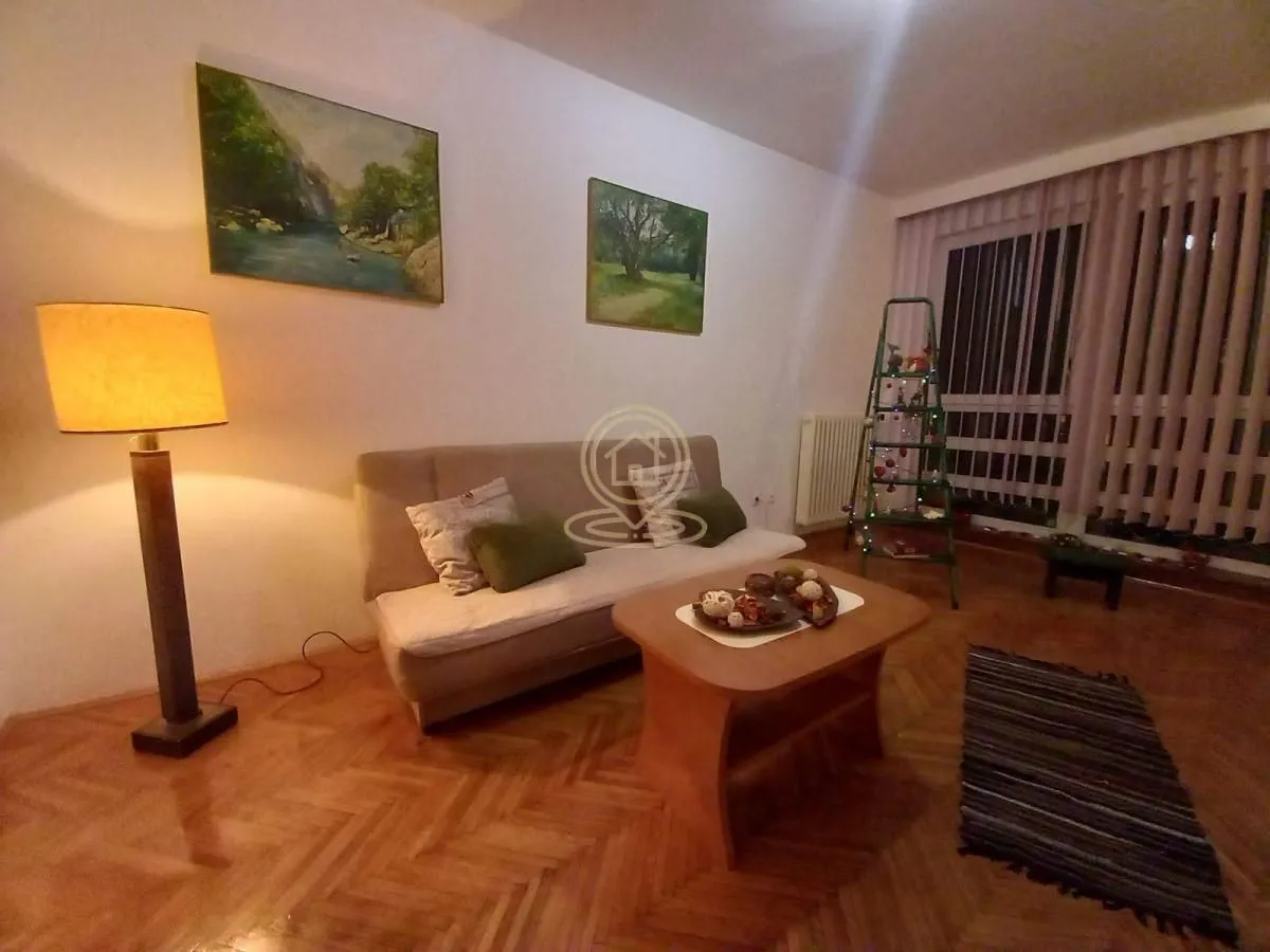 Living room with a sofa, coffee table, and floor lamp.
