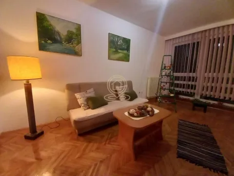 Living room with a sofa, coffee table, and floor lamp. - image 4