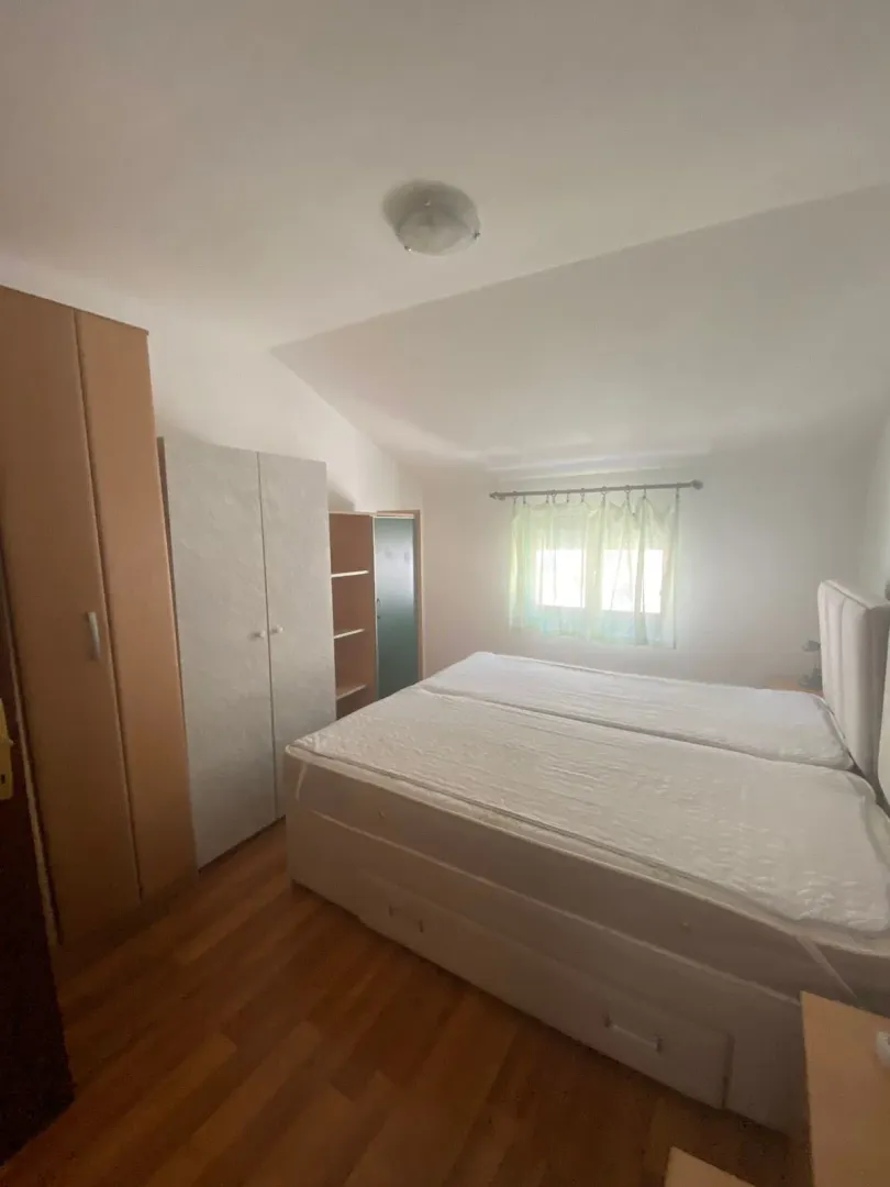 Bedroom with a double bed, wardrobes, and a window.