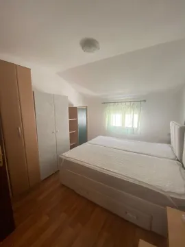 Bedroom with a double bed, wardrobes, and a window. - image 2