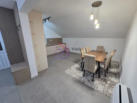 Dining area with a wooden table and chairs adjacent to the kitchen. - image 5