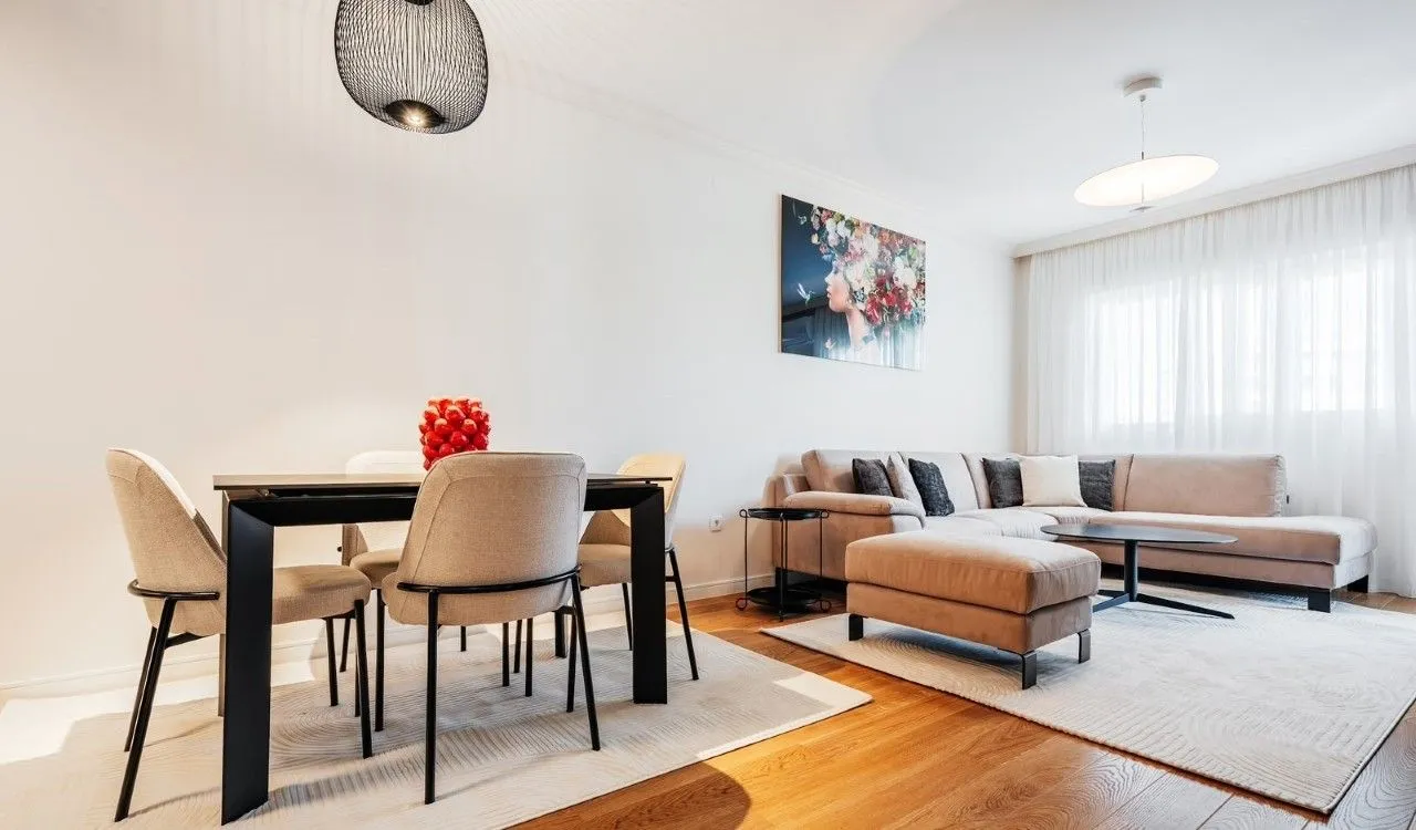 Spacious living room with a sofa set and a dining table.